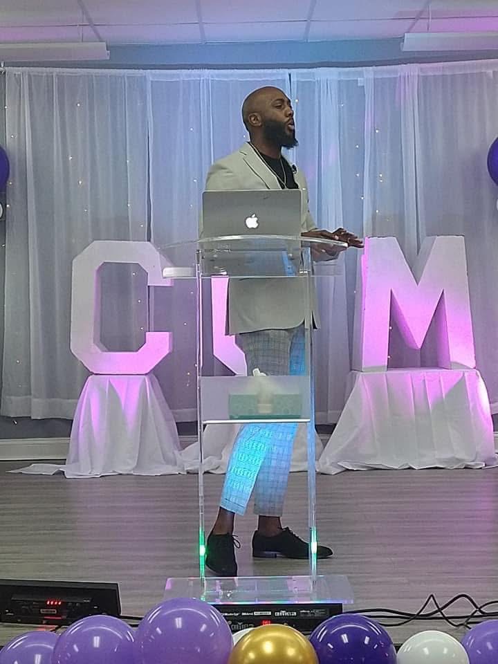 Brandon presenting from a clear podium