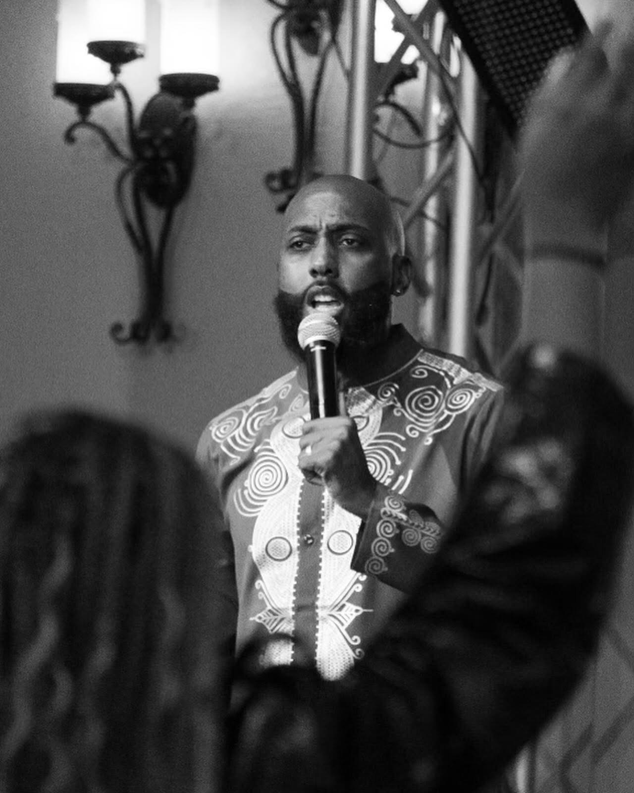 Black and white portrait of Brandon speaking